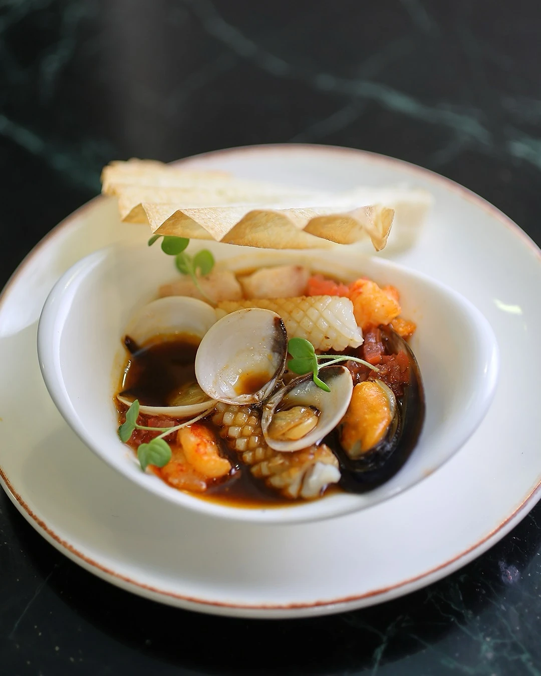 Sopa de mariscos francesa, intensa y vibrante. Inspirada en Il Tabarro, el primer acto de Il Trittico, donde el drama flota bajo la superficie.